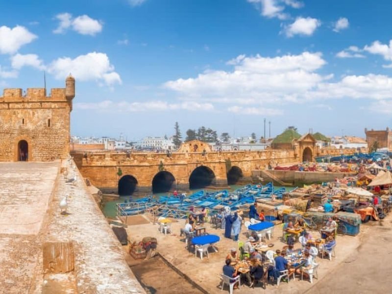 People eating street food in old fishing port Essaouira, Morocco