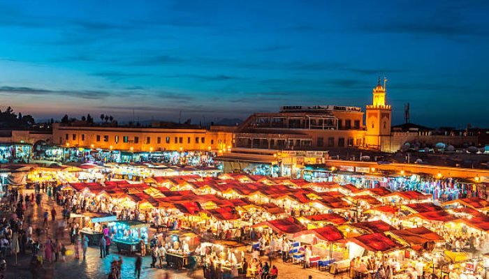 Famous Djemaa El Fna Square in early evening light, Marrakech, Morocco with the Koutoubia Mosque, Northern Africa.Nikon D3x